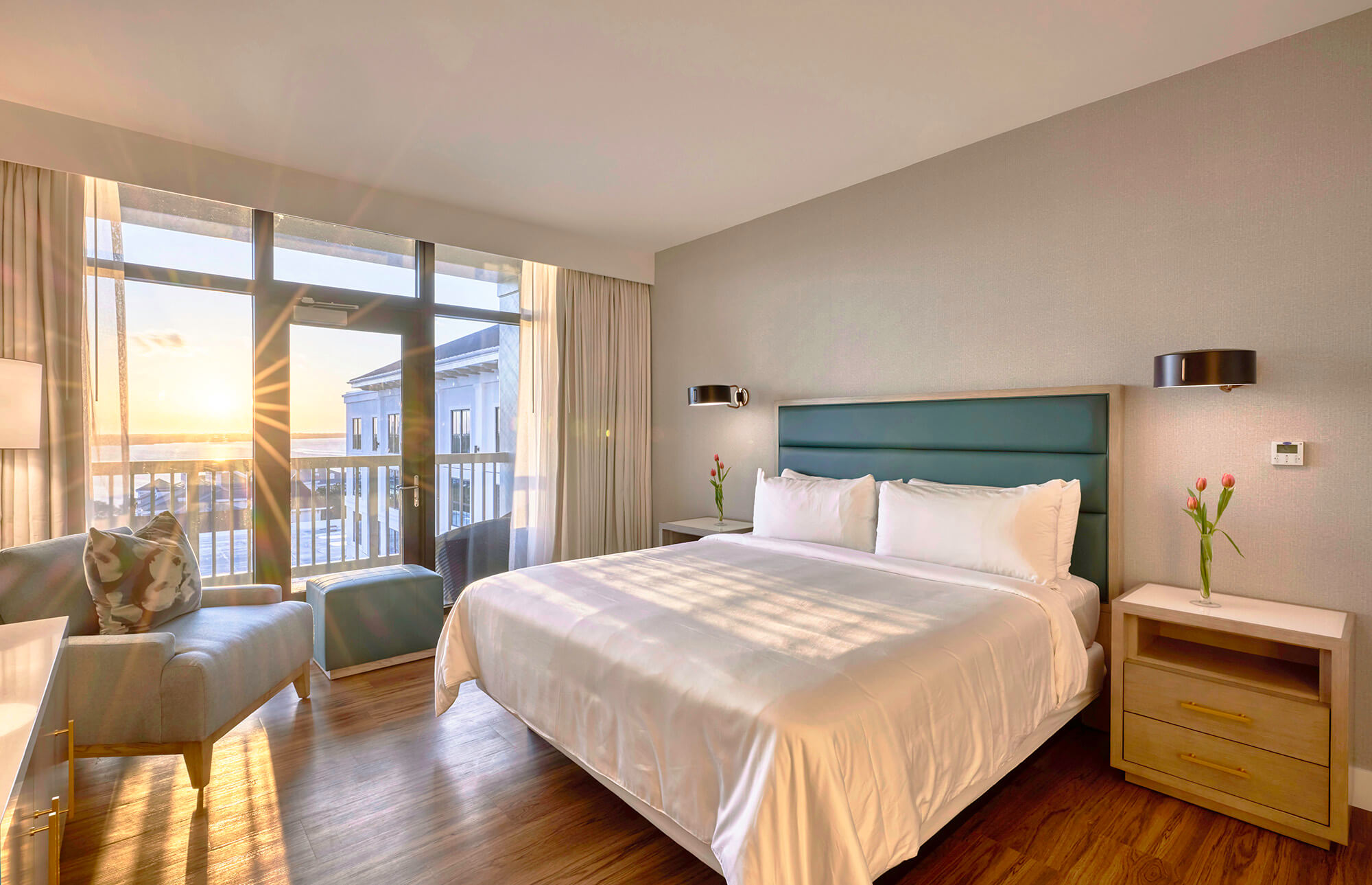 A Presidential room at the Hotel Effie, with a large King bed adjacent to a sun-streaked bay window