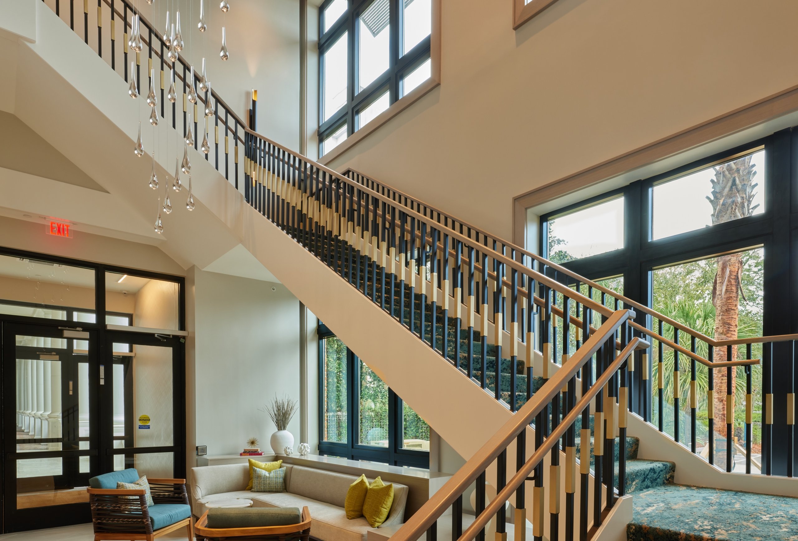 The Hotel Effie's grand lobby staircase, with a black and brown balustrade