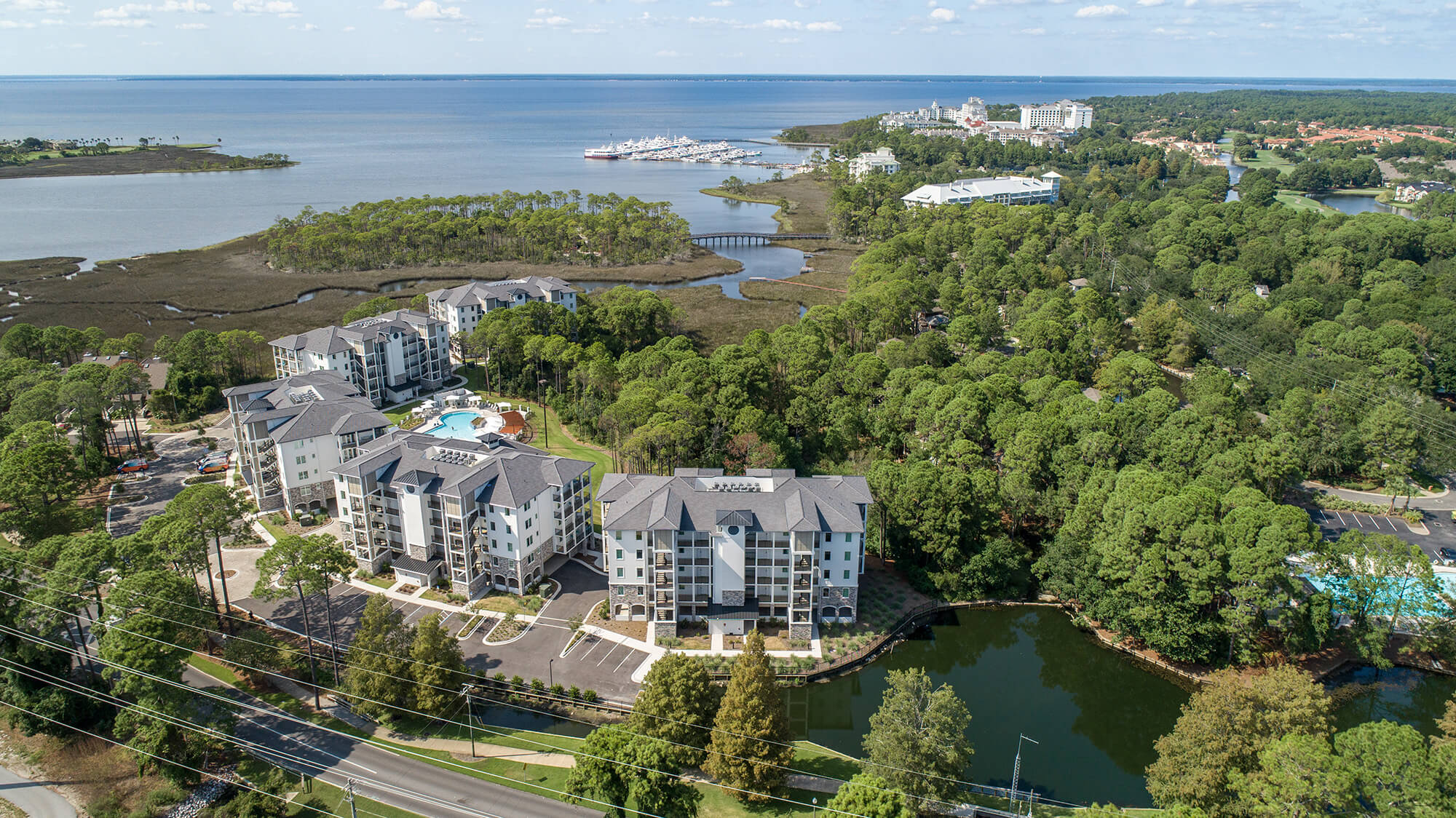 An aerial view of Osprey Pointe, in a wooded area overlooking the ocean